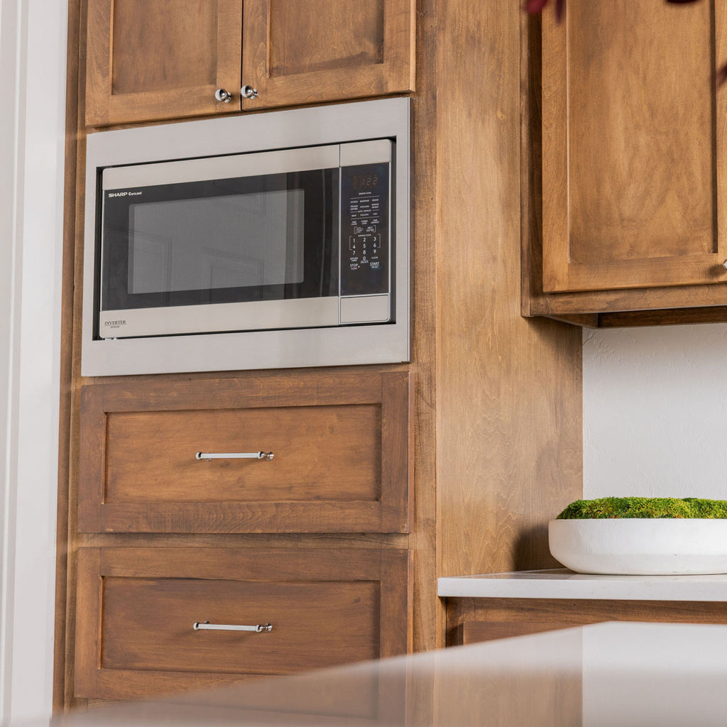 Close-up view of a Sharp Carousel microwave with a precision-fit brushed stainless steel trim kit