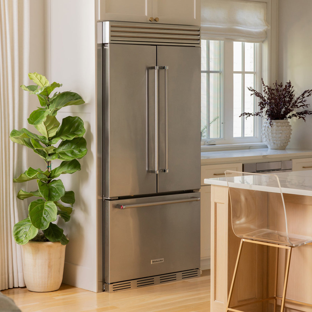 Full kitchen view of a built-in French door refrigerator featuring both top and bottom grilles