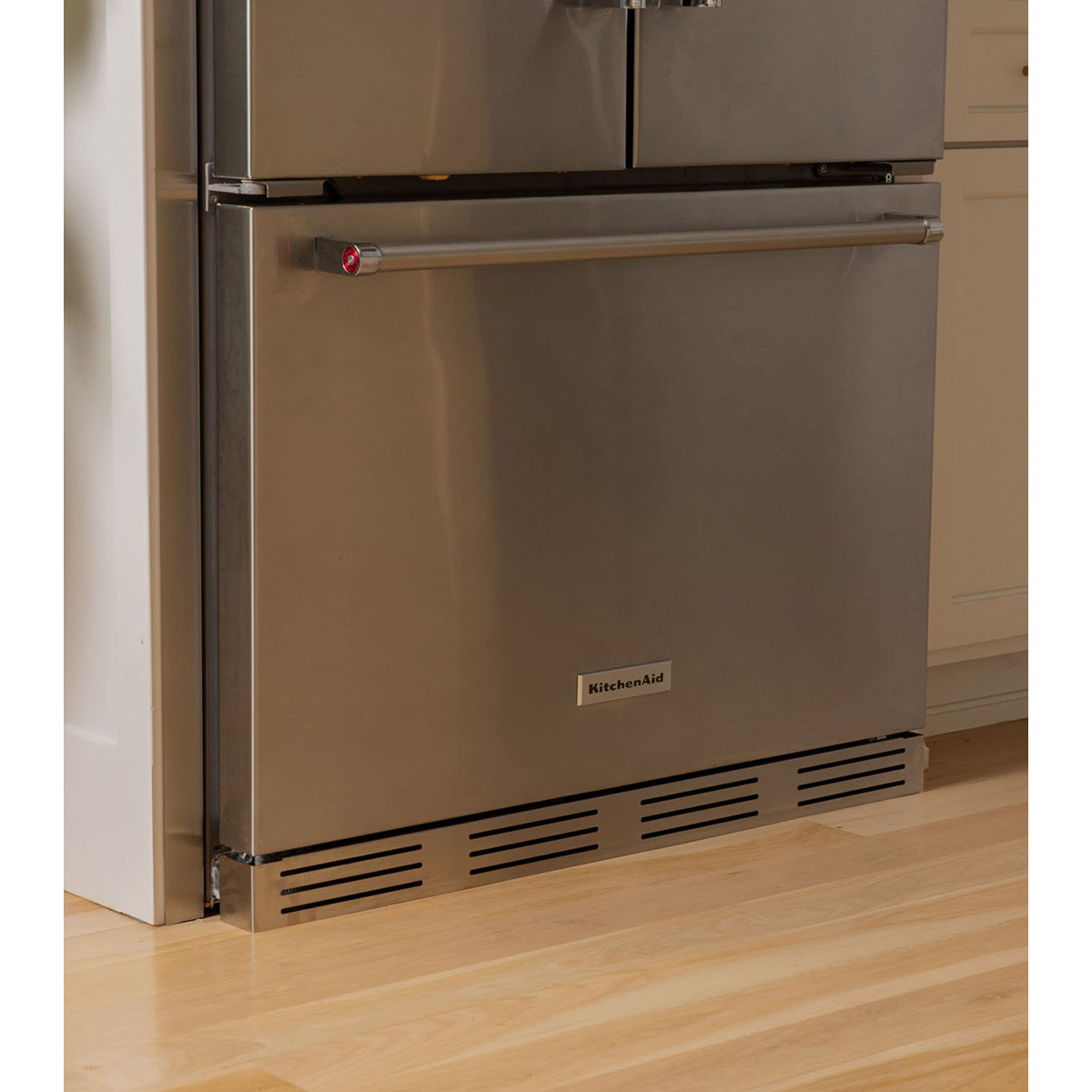 KitchenAid French Door refrigerator with a custom stainless steel bottom ventilation grille installed for a built-in look