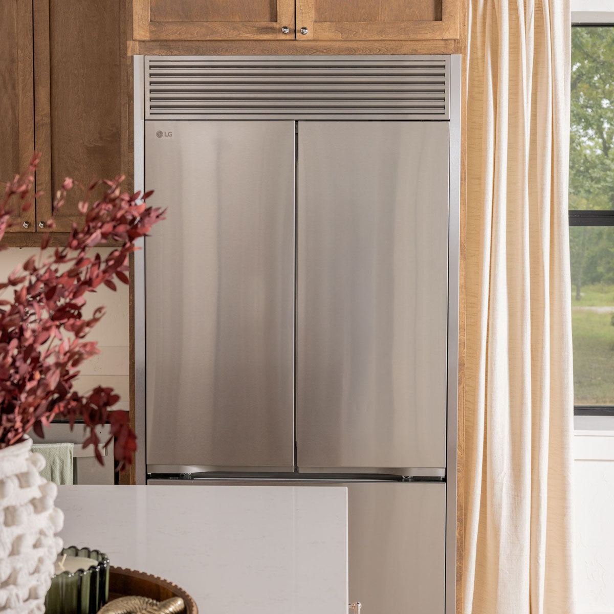 LG Side-by-Side refrigerator with a custom Appliance Trim Kit installed for a seamless built-in finish