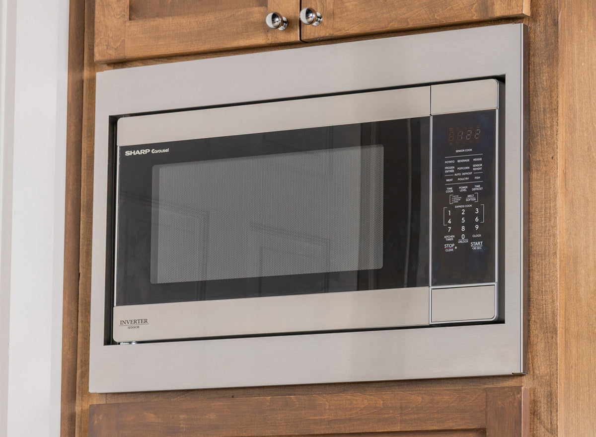 Precision-fit brushed metal trim kit for Sharp Carousel Inverter microwave in warm wood cabinets