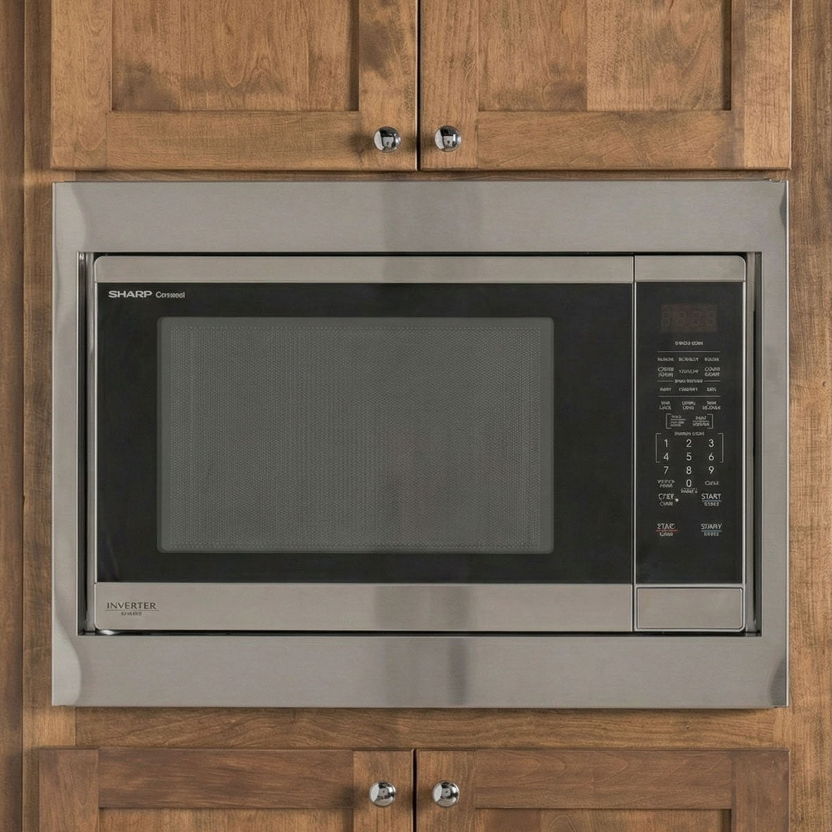 Custom brushed stainless steel trim kit for Sharp Carousel microwave providing a precision built-in look in wood cabinetry